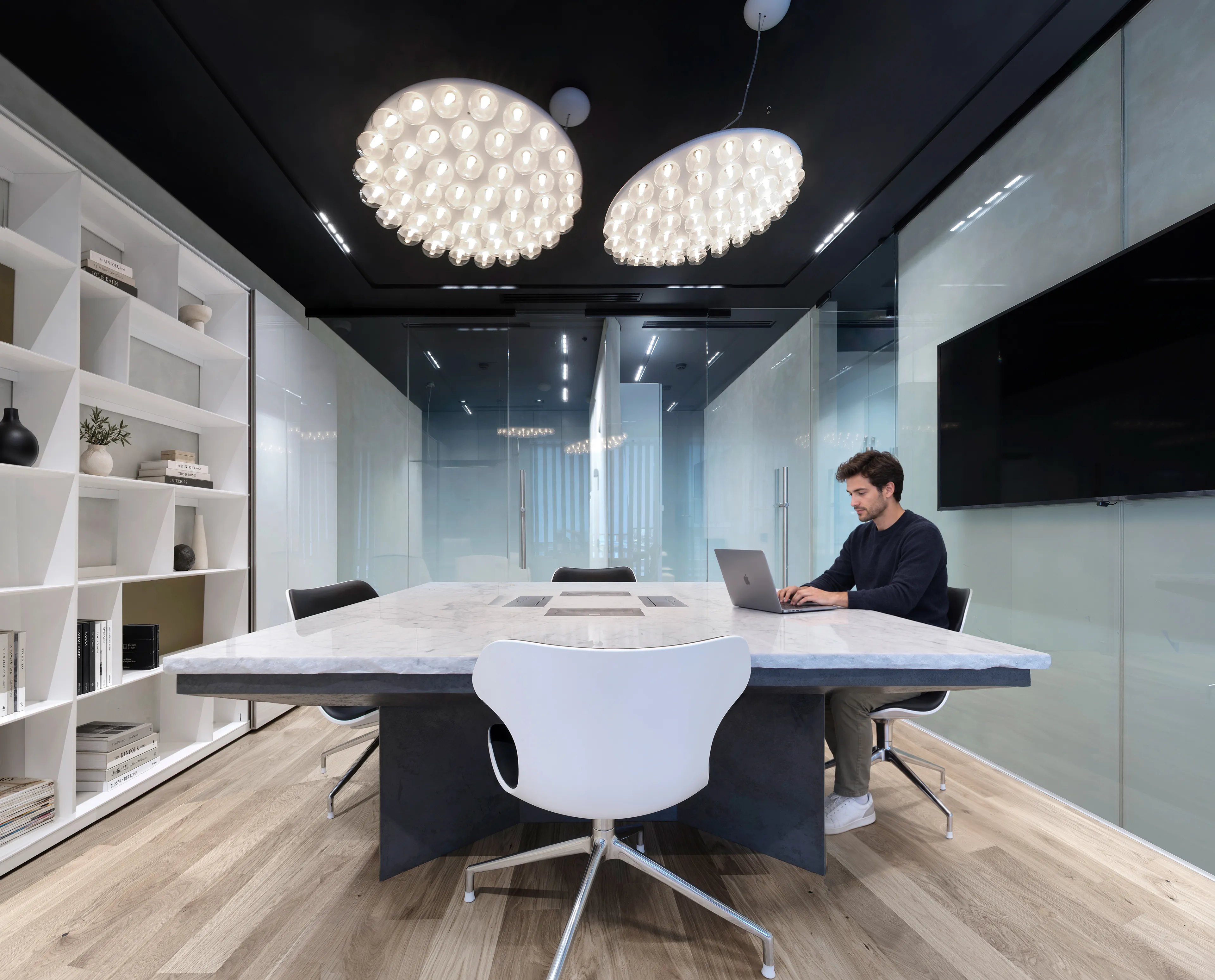 The completed Literator office, with its shared table, glass enclosure and shelving